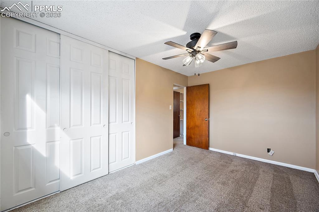 Image 23 of 38: Bedroom 3, carpet and ceiling fan.