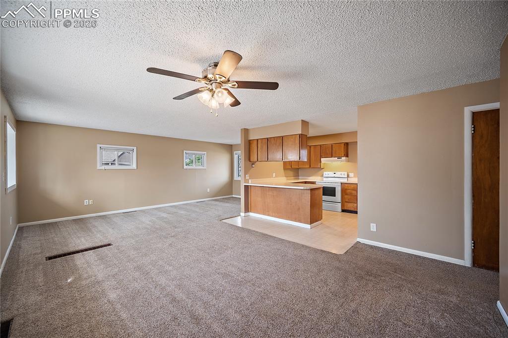 Image 7 of 38: View from the back door to the yard and detached garage.