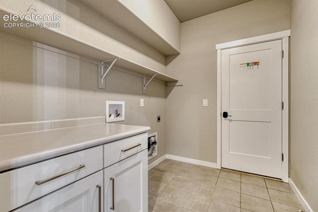 Image 18 of 43: laundry on main leading to garage