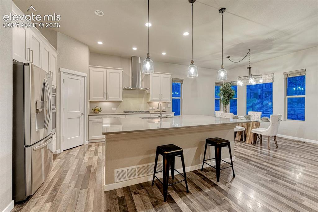 Image 2 of 43: Beautiful kitchen with walk in pantry, oversized bar with seating area and
