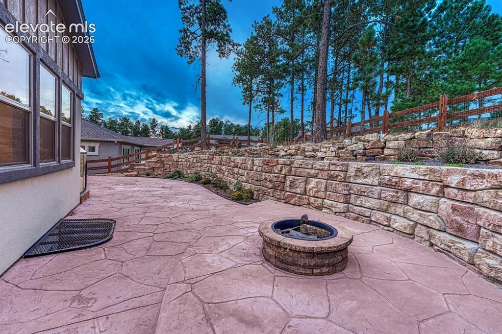 Image 35 of 43: custom firepit offering privacy and plenty of room to entertain