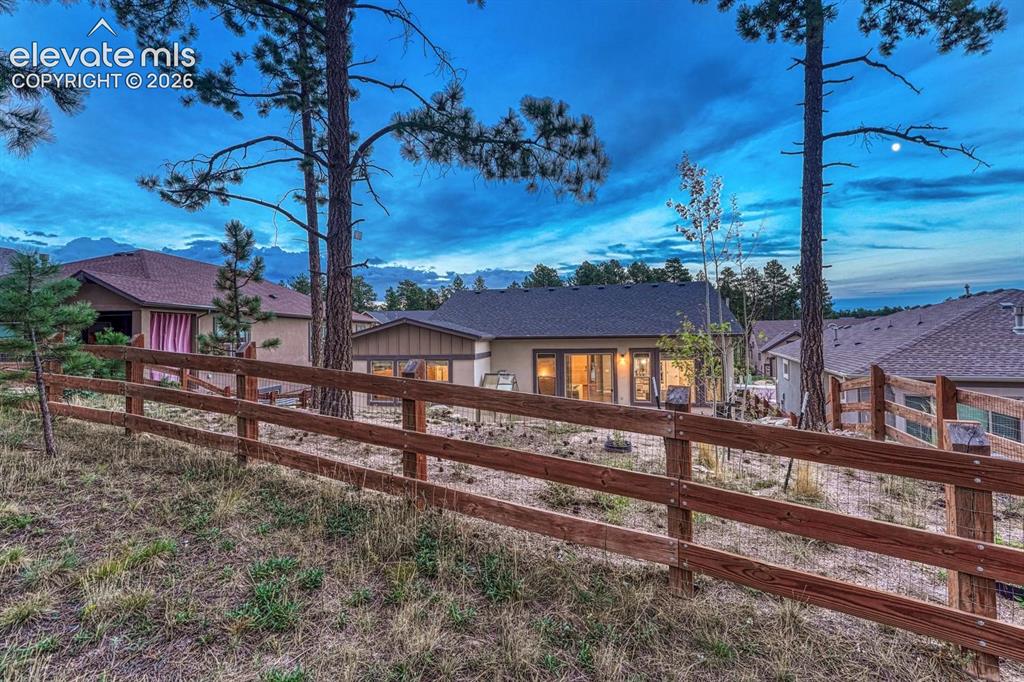 Image 37 of 43: fenced in backyard that backs to small common area