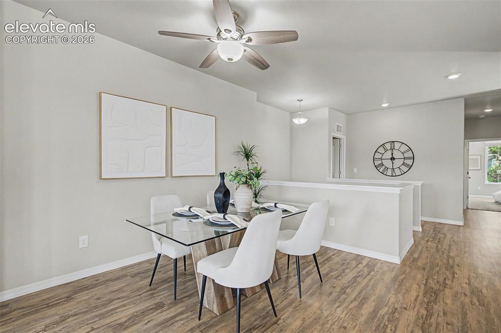 Image 15 of 45: Dining area featuring wood-finish flooring, a ceiling fan with integrated l