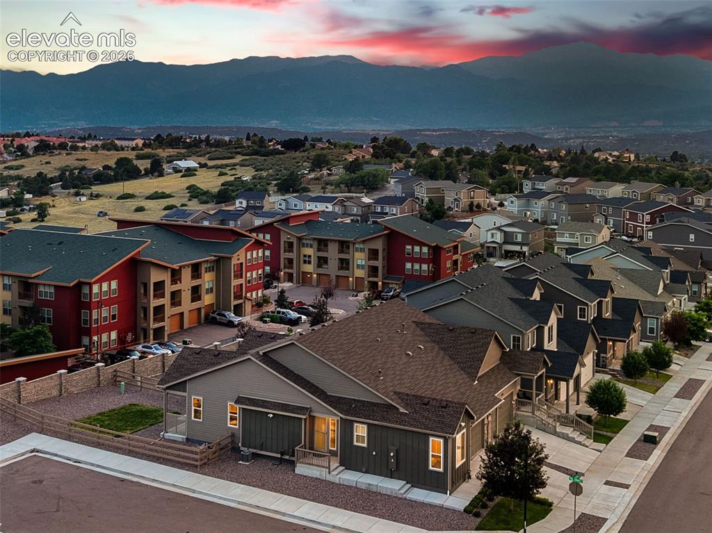 Image 2 of 45: Mountain backdrop with residential properties and varied rooflines