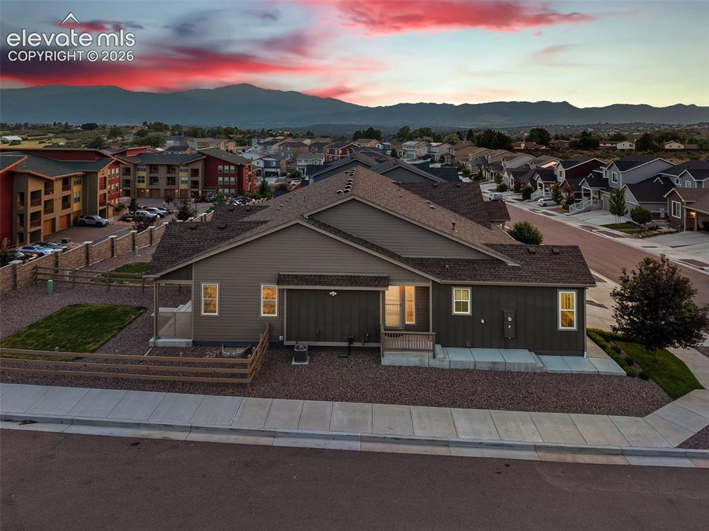 Image 3 of 45: Contemporary siding exterior with a covered patio, gravel landscaping, and