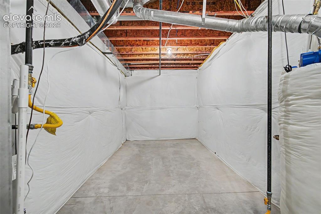Image 40 of 45: Unfinished basement area featuring a concrete floor, exposed wood ceiling j