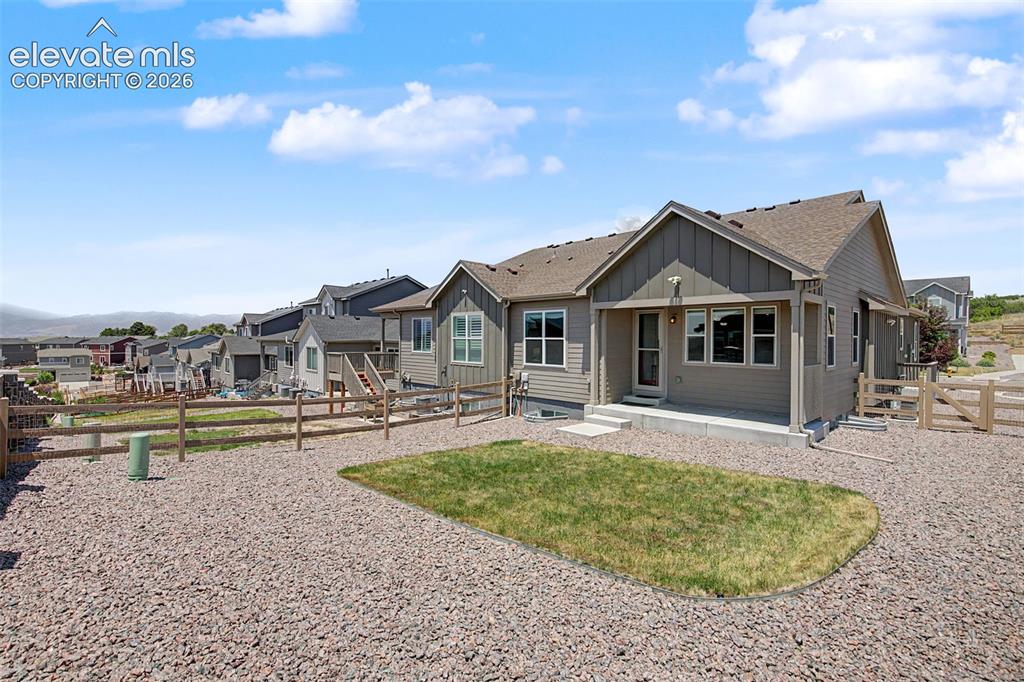 Image 42 of 45: Single-story residence featuring composite siding and a covered patio