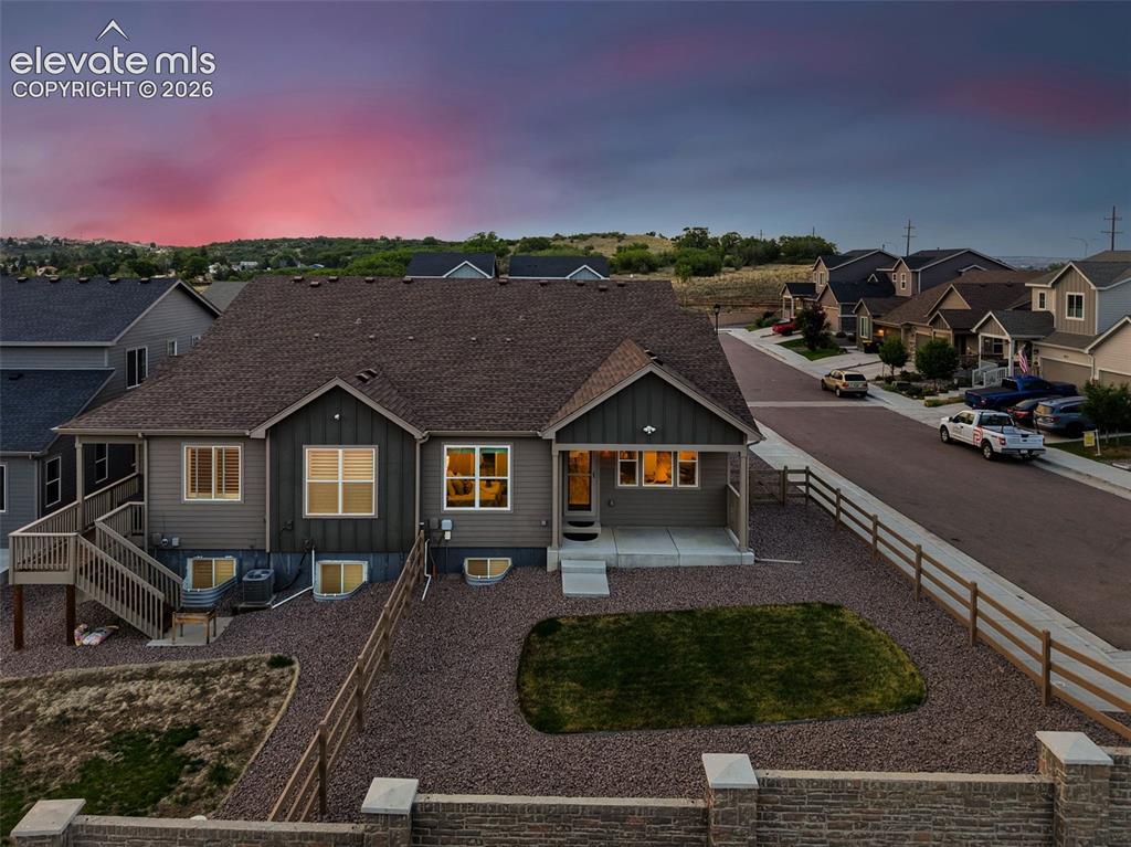 Image 45 of 45: Contemporary two-story residence featuring grey siding and a dark shingle r