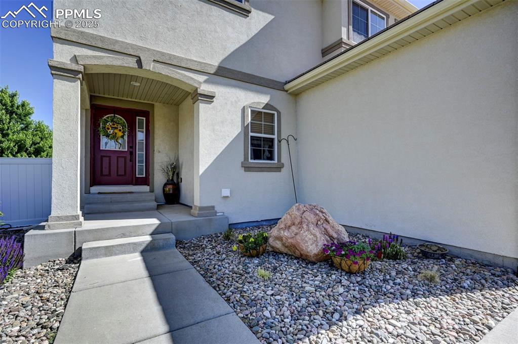 Image 12 of 50: Property entrance with stucco siding