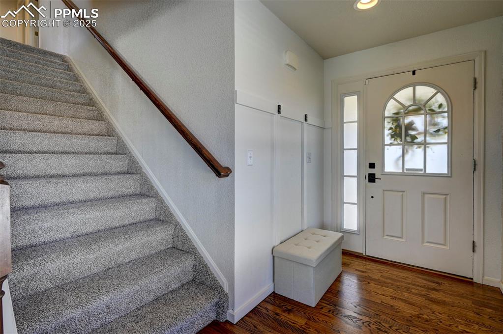 Image 17 of 50: Entryway featuring stairway, wood finished floors, and recessed lighting