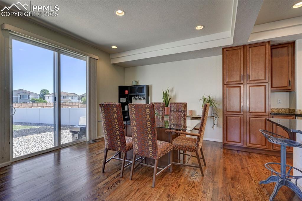 Image 23 of 50: Dining room featuring dark wood-type flooring and recessed lighting
