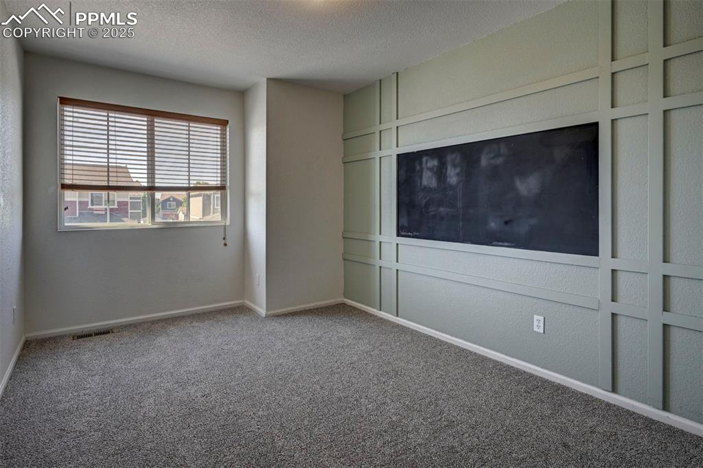 Image 36 of 50: Unfurnished bedroom with carpet floors and a textured ceiling