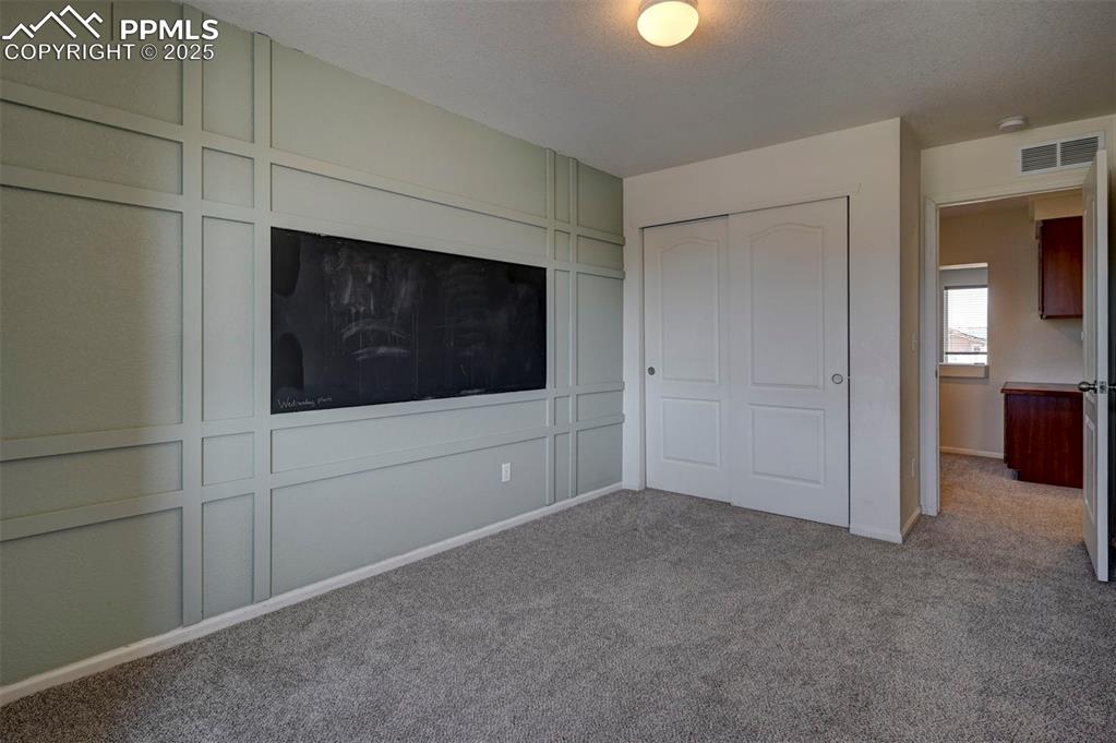 Image 37 of 50: Unfurnished bedroom with carpet flooring and a closet