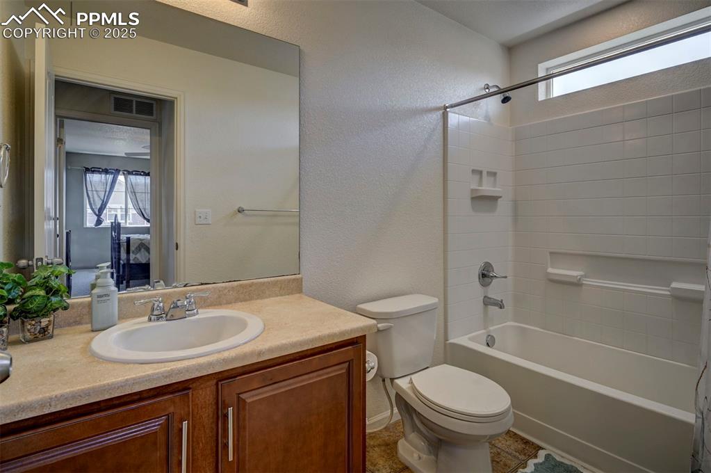 Image 38 of 50: Bathroom featuring vanity, shower / tub combination, healthy amount of natu