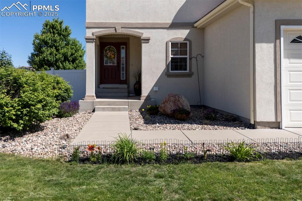 Image 4 of 50: View of exterior entry with stucco siding