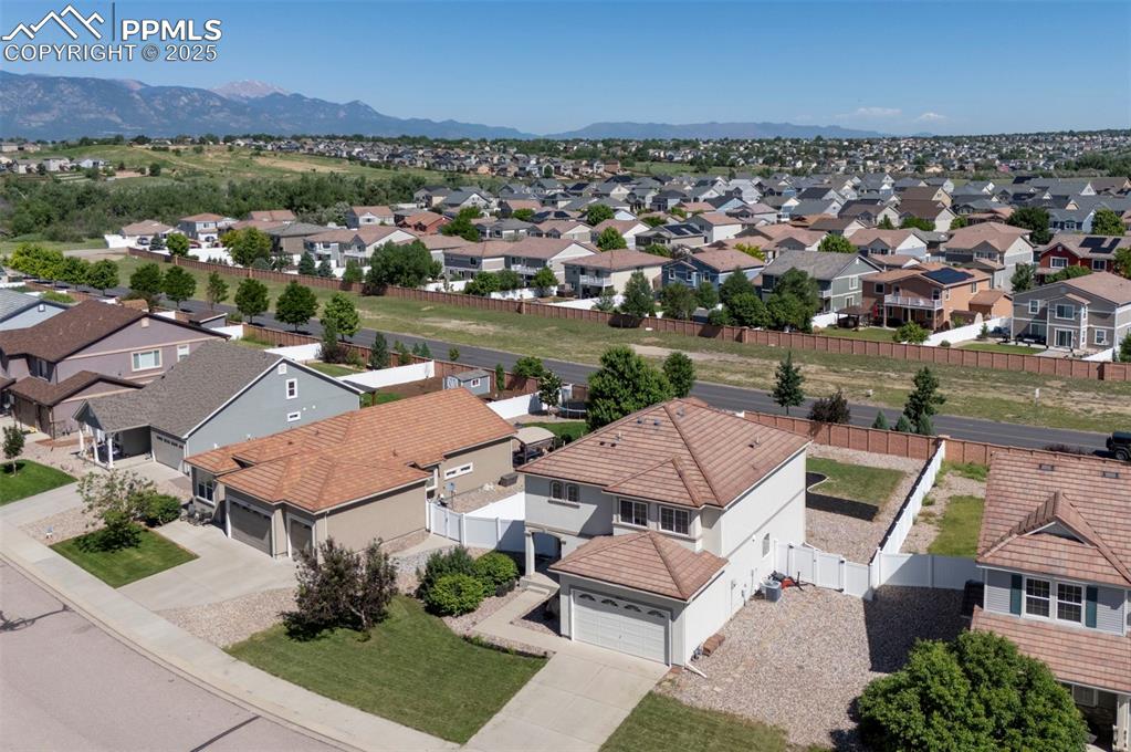 Image 9 of 50: Aerial view of residential area with a mountain backdrop