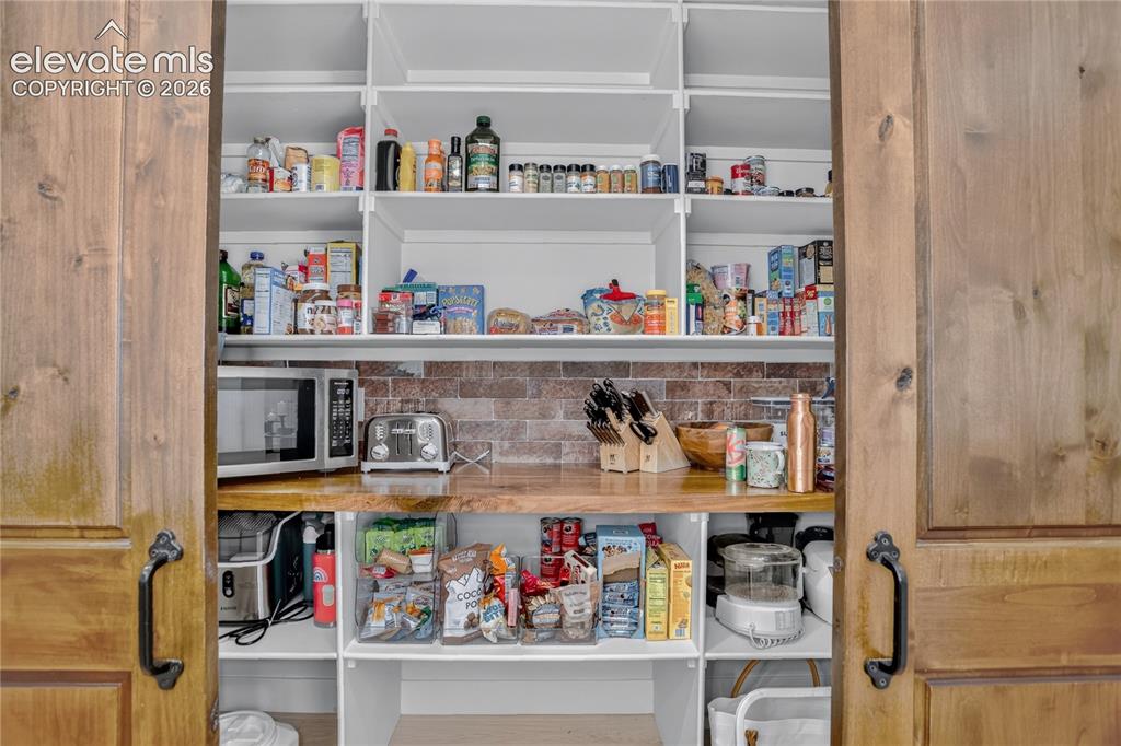 Image 11 of 47: Barn-door pantry w/ built-in organization