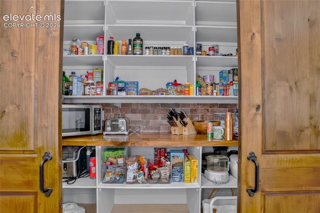 Image 11 of 47: Barn-door pantry w/ built-in organization