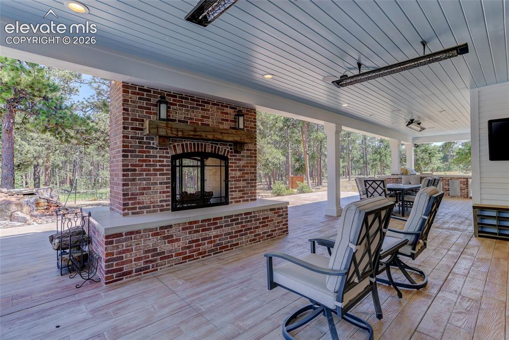 Image 14 of 47: Patio w/ fireplace & heaters
