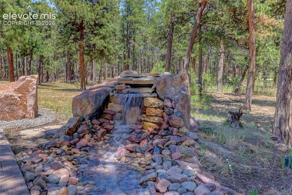 Image 16 of 47: Water feature adds ambience to outdoor entertaiment