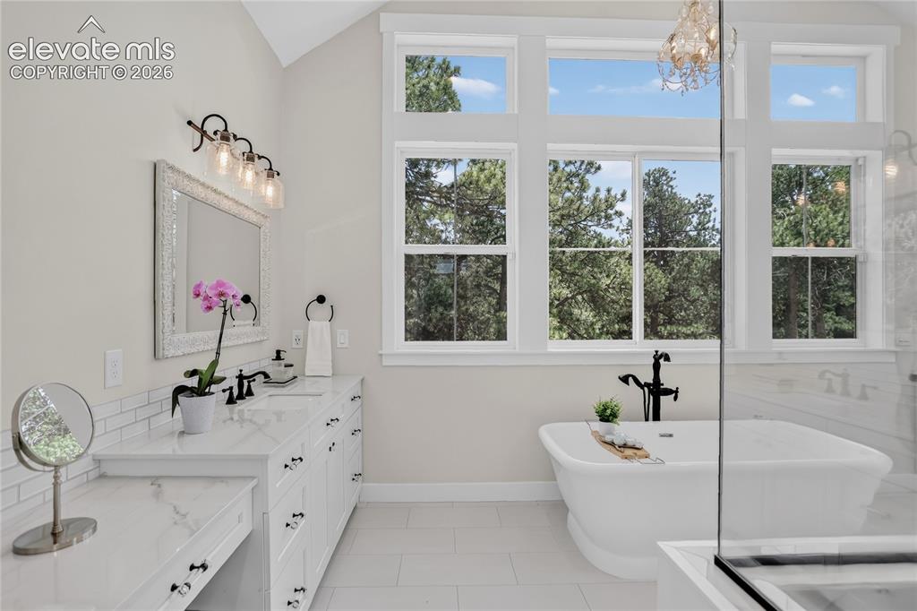 Image 23 of 47: Primary bath w/ separate vanities & makeup vanity