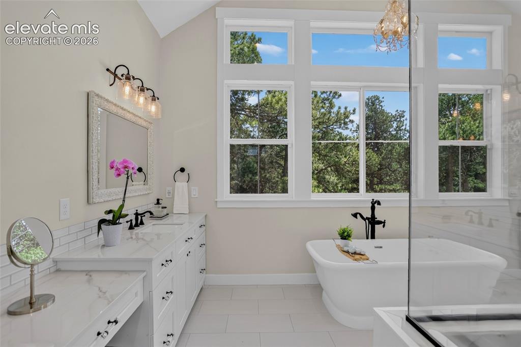 Image 23 of 47: Primary bath w/ separate vanities & makeup vanity
