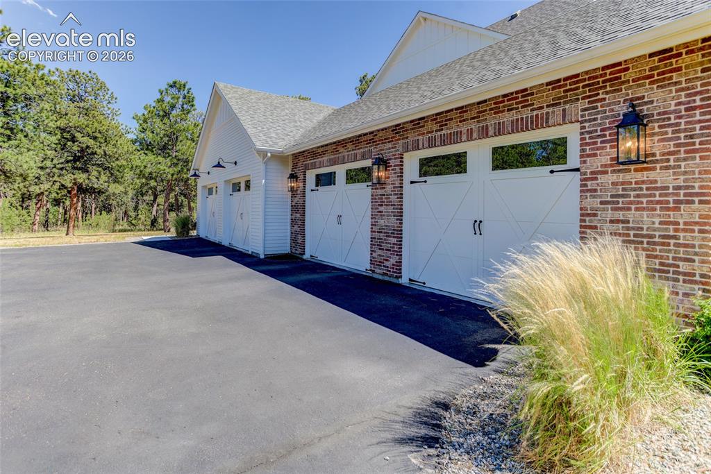 Image 37 of 47: 5-car tandem garage for main house w/ EV charger
