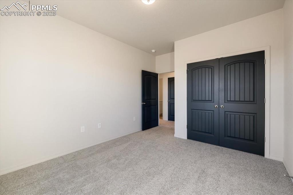 Image 12 of 22: Unfurnished bedroom featuring carpet floors and a closet
