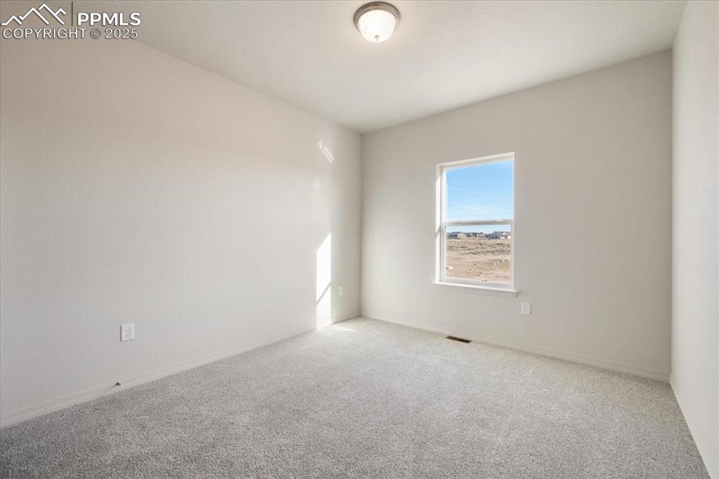 Image 13 of 22: Spare room featuring carpet and baseboards