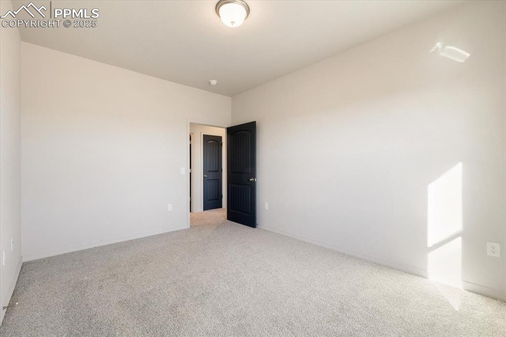 Image 15 of 22: Carpeted empty room with baseboards