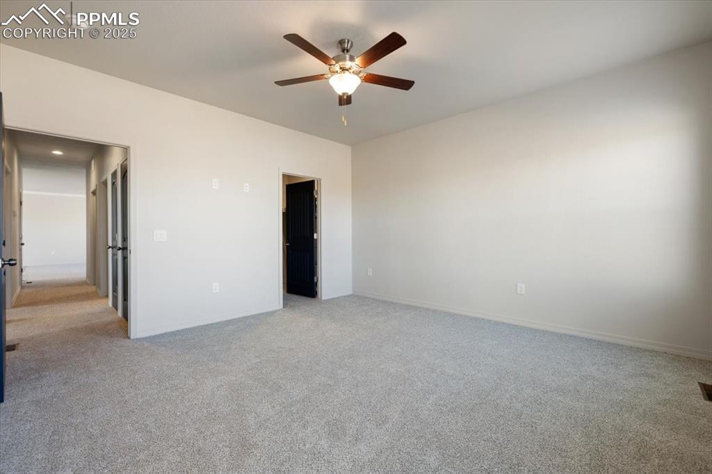 Image 18 of 22: Unfurnished bedroom featuring light carpet and a ceiling fan