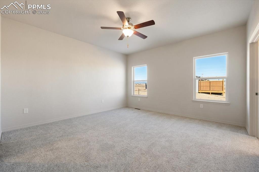 Image 19 of 22: Spare room featuring carpet and a ceiling fan