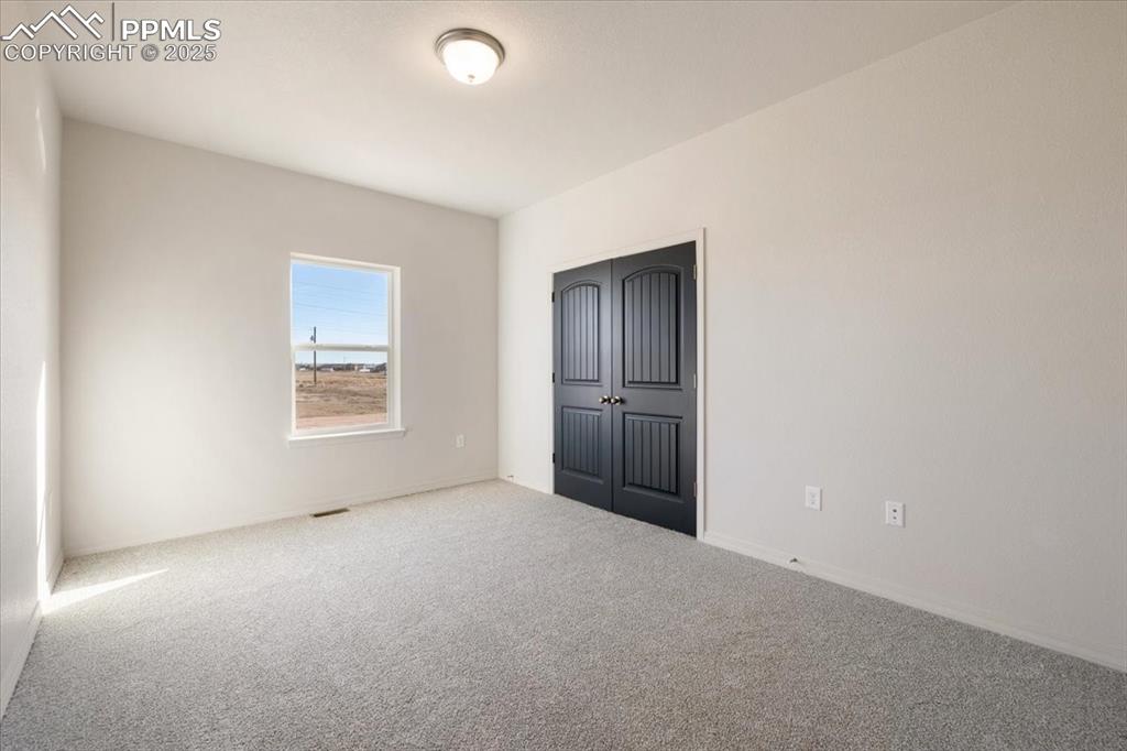 Image 2 of 22: Unfurnished bedroom featuring carpet and a closet