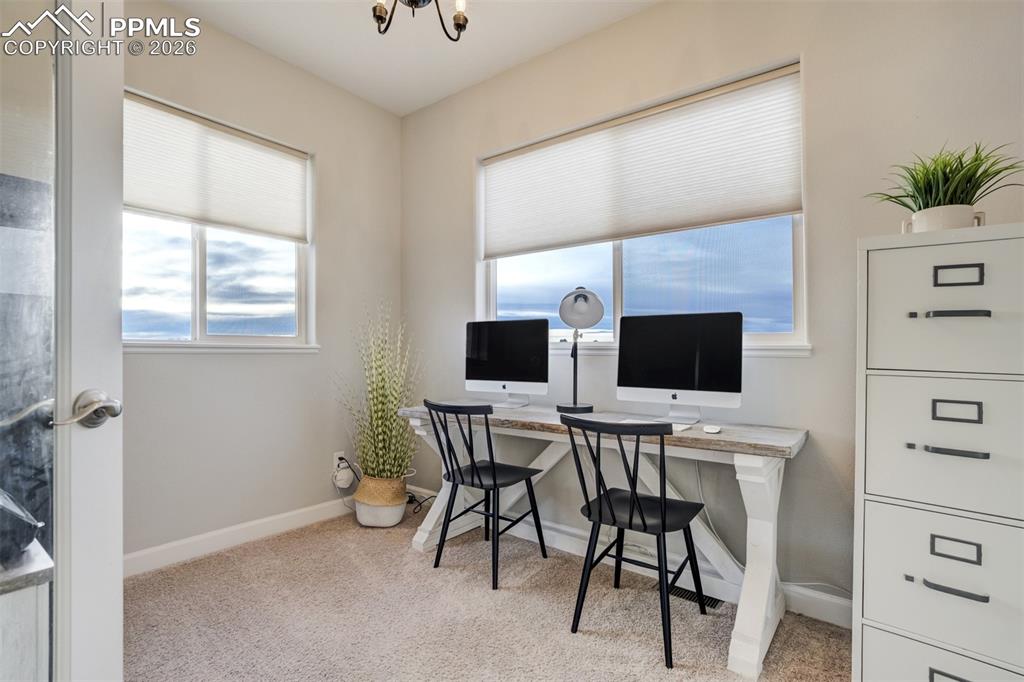 Image 17 of 50: Office just off the living room, separated by doors. 