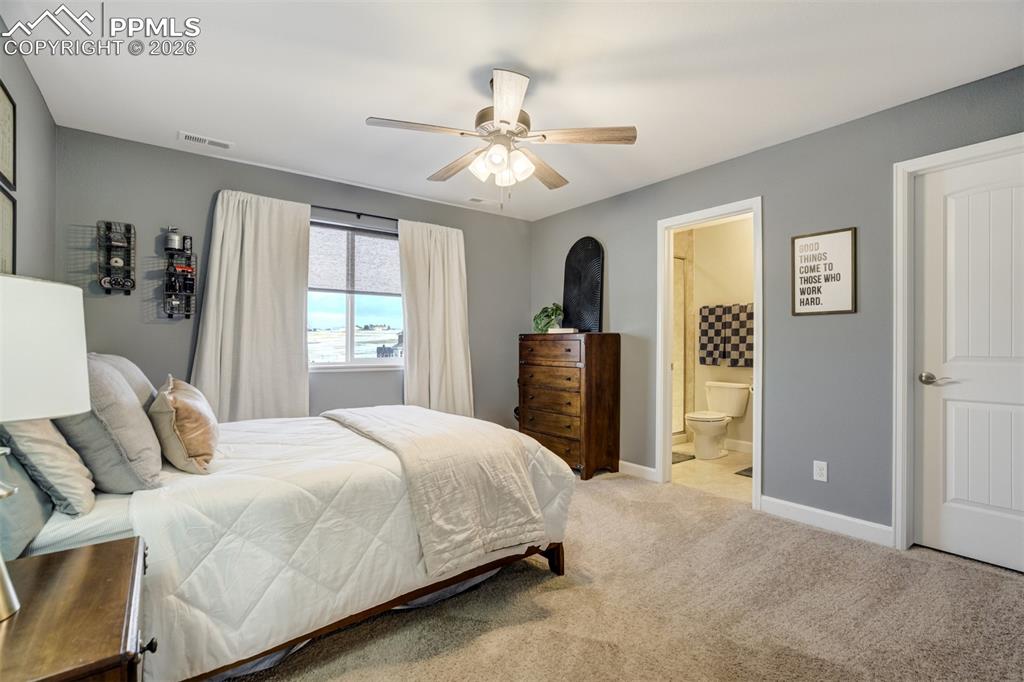 Image 28 of 50: Bedroom 2 upstairs has a private on-suite bathroom. 