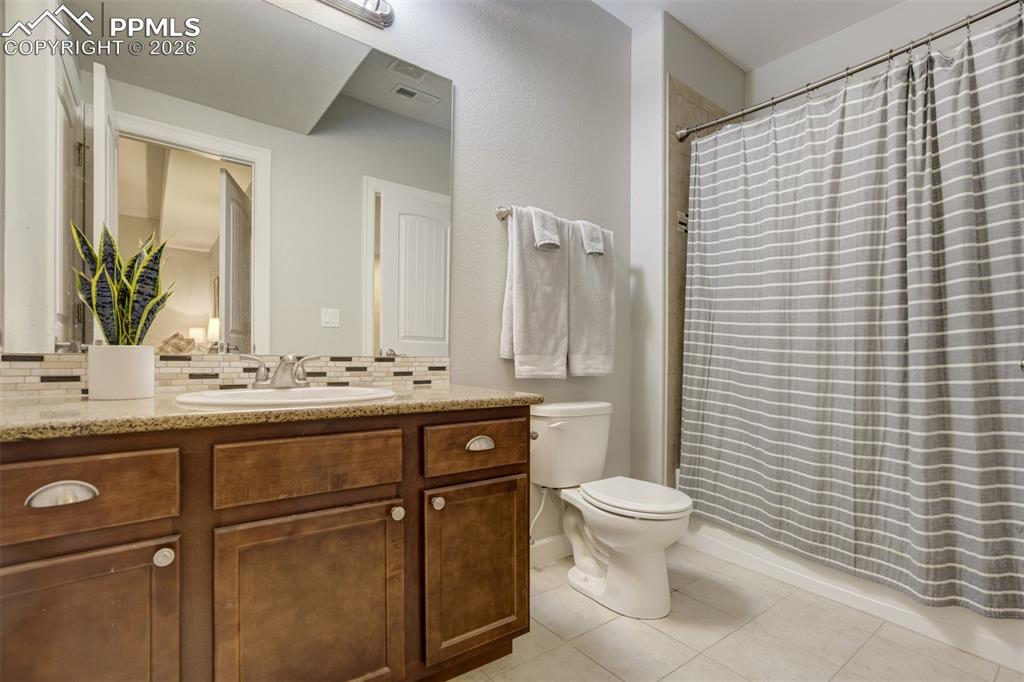 Image 42 of 50: Attached full bathroom in the basement.