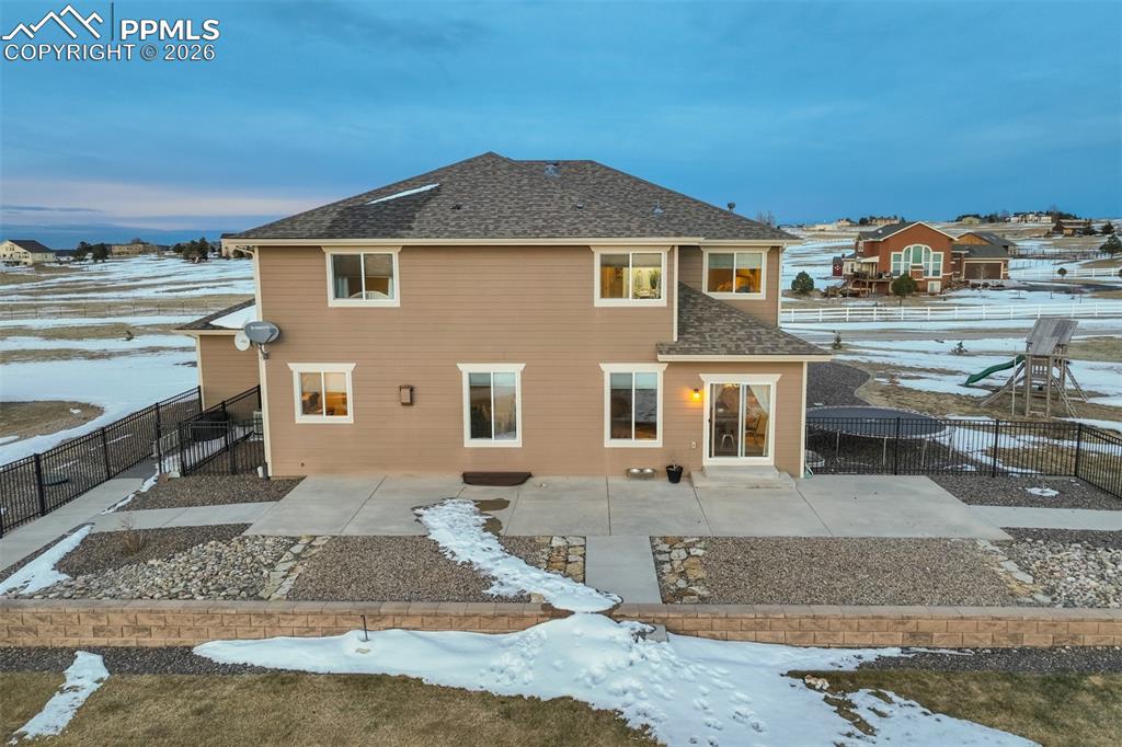 Image 45 of 50: Extended concrete patio, low maintenance landscaping, and fenced in area. 