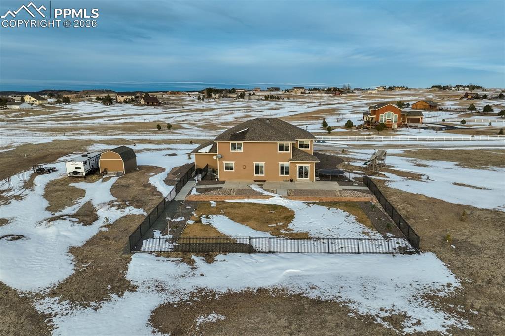 Image 47 of 50: View from the backyard with a smaller fenced in area. 
