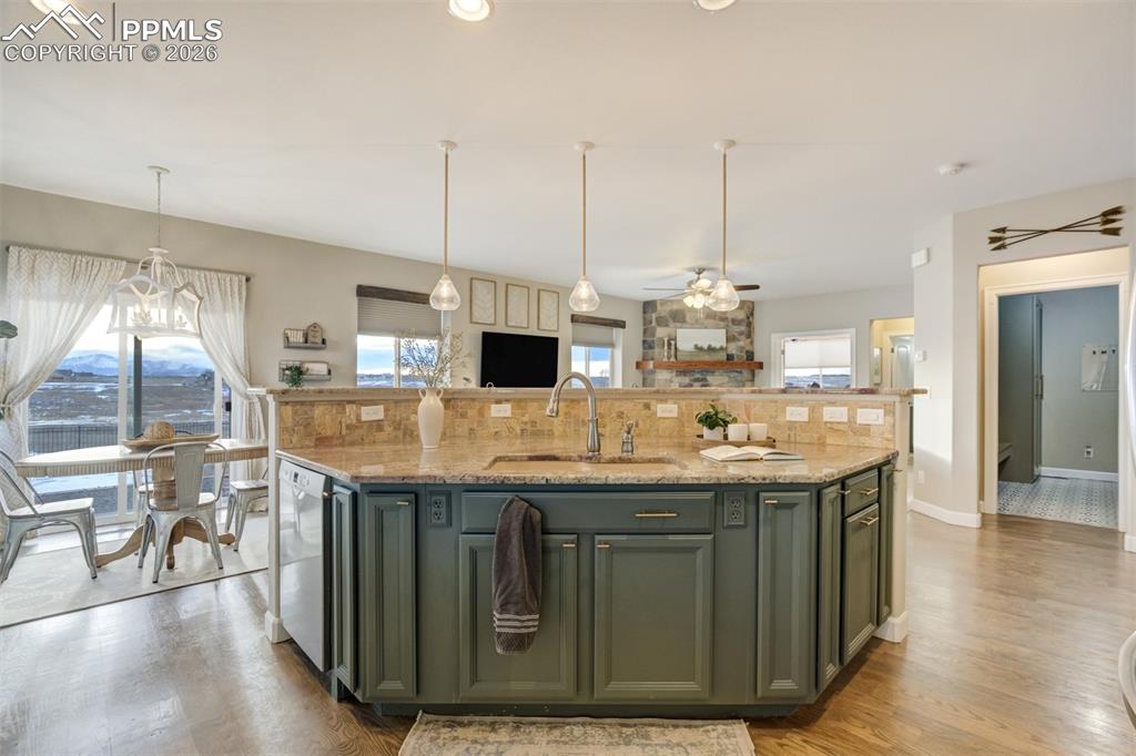 Image 8 of 50: Large kitchen island that overlooks into the living room. 