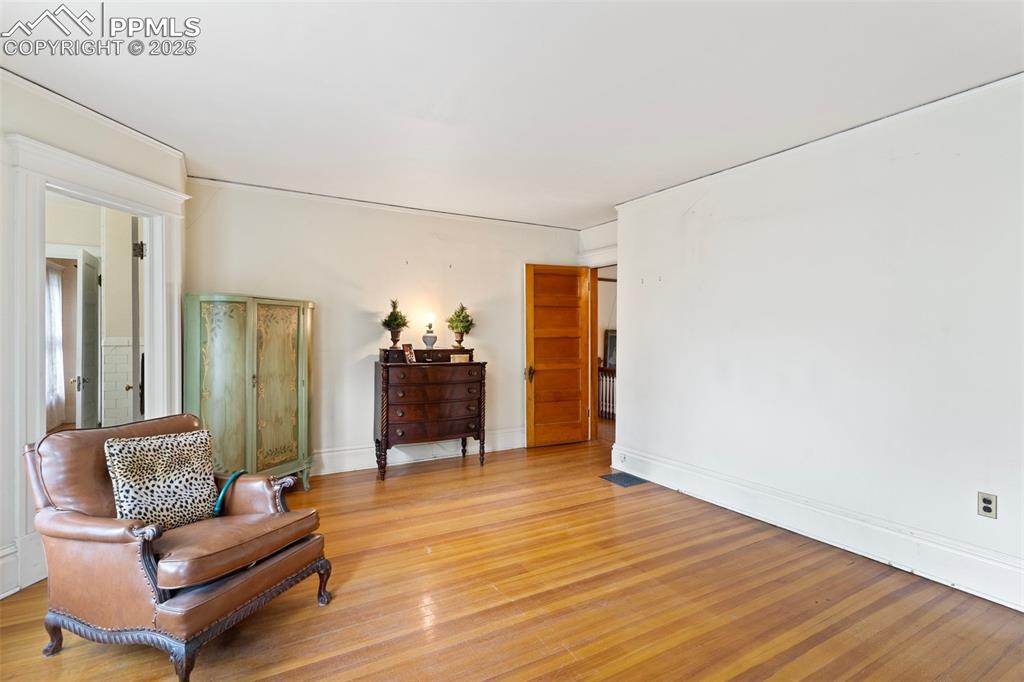 Image 33 of 50: Sitting room with light wood-style flooring and baseboards