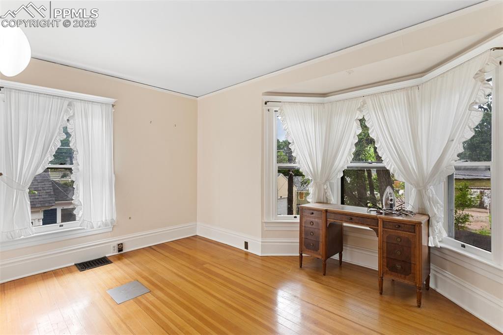 Image 34 of 50: Office area featuring healthy amount of natural light and light wood finish