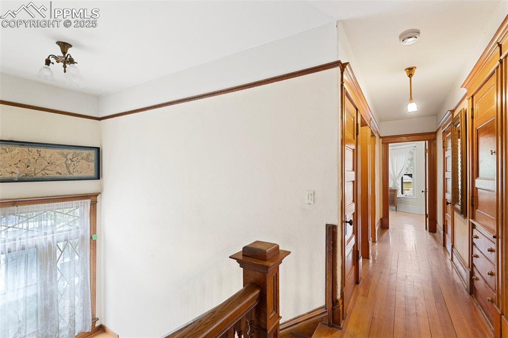 Image 41 of 50: Corridor featuring light wood-type flooring and baseboards