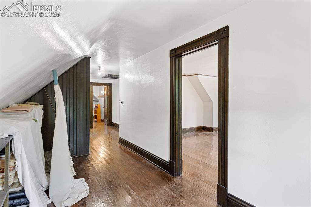 Image 43 of 50: Corridor featuring hardwood / wood-style flooring and baseboards