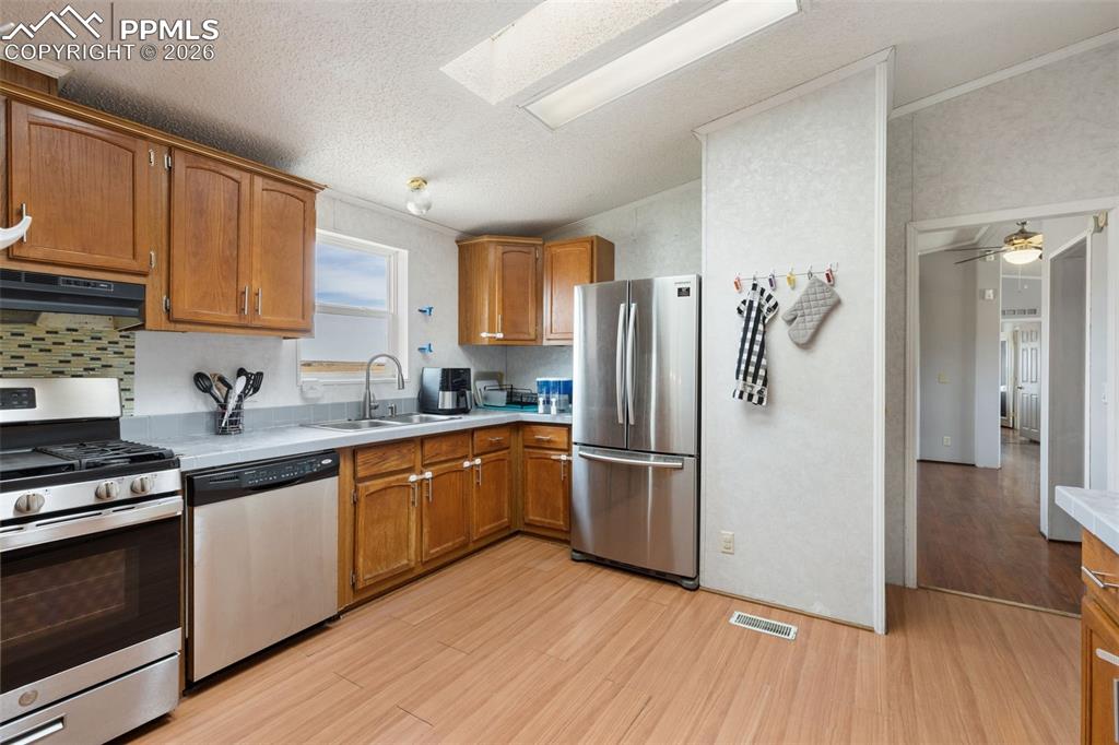 Image 12 of 34: Kitchen with Stainless Steel Appliances