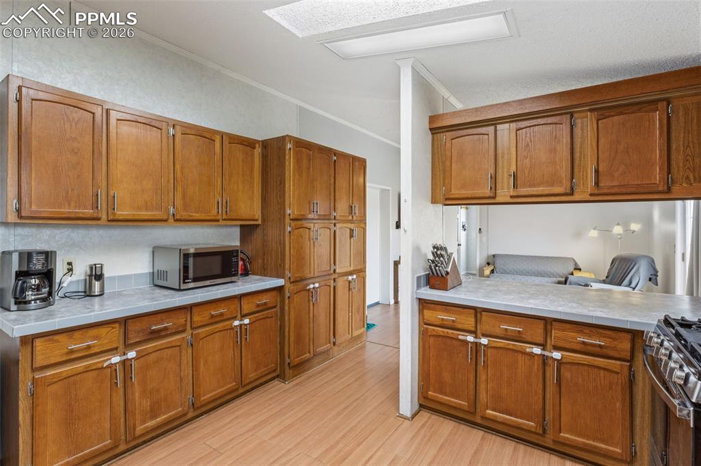 Image 14 of 34: Kitchen with Abundant Cabinetry