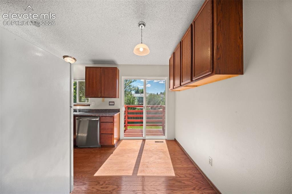 Image 15 of 40: Wood-finish flooring with a sliding glass door providing outdoor access