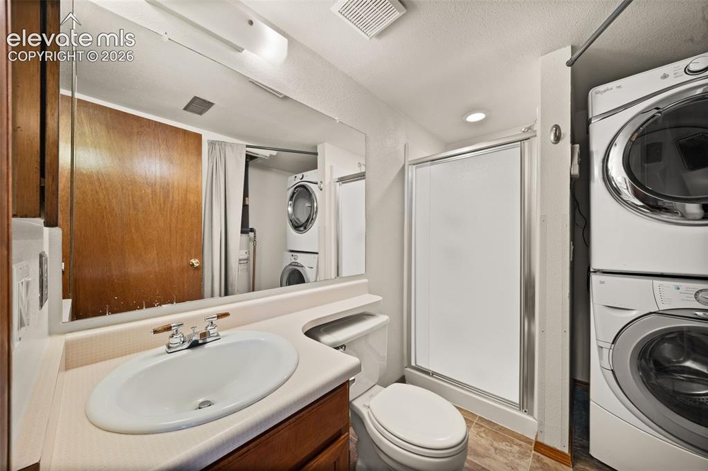 Image 28 of 40: Vanity with an integrated sink, framed mirror, and chrome faucet