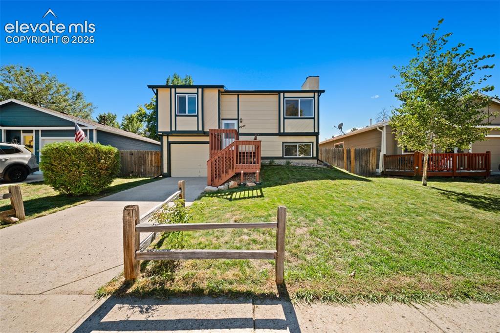 Image 6 of 40: Two-story residence with a multi-level exterior, an attached garage, a pave