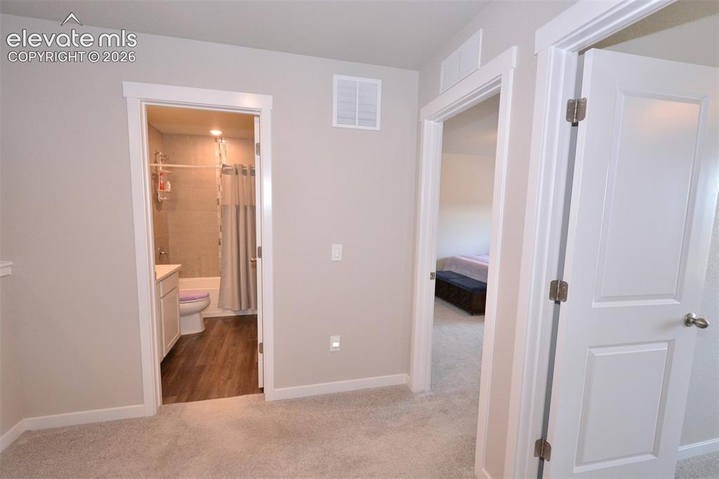 Image 17 of 27: hallway to bathroom, bedrooms & Laundry on upper level