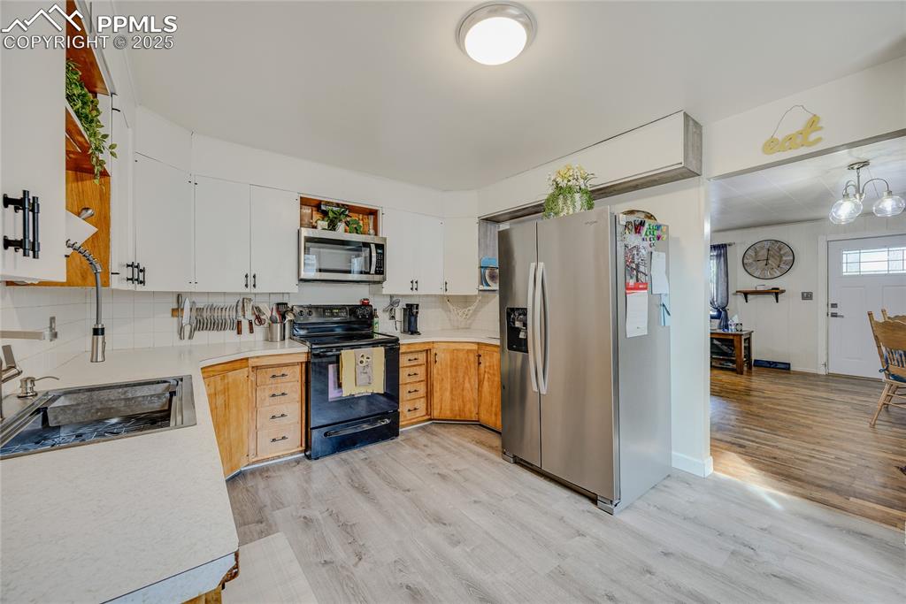 Image 12 of 31: Kitchen featuring light countertops, appliances with stainless steel finish